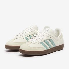 Rule the streets and the pitch with the adidas Originals Womens Samba OG in Cloud WhiteHaze GreenWonder White, featuring an iconic 3stripes look in smooth leather and reinforced toe, straight from the archives. The adidas Originals Womens Samba OG is a revisit to the classic Samba design, still relevant and sliding onto your feet for superb style over 70 years later. Smooth leather and serrated 3stripe overlays looks just as good now as they did back in the day, adding a touch of retro to your d Sambas Adidas, Tennis Shoe Outfits Summer, Samba Shoes, Shoes For School, Preppy Shoes, Training Clothes, Cute Sneakers, Adidas Outfit