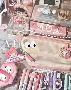 an assortment of stationery items on display in a case with hello kitty stickers