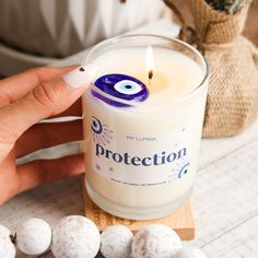 a person lighting a candle with cotton balls around it