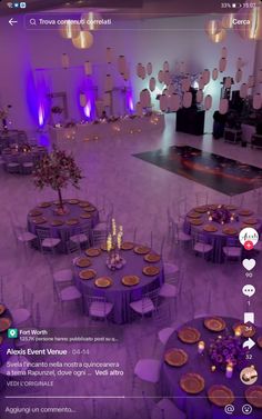 an image of a room with tables and chairs set up for a wedding reception in purple lighting