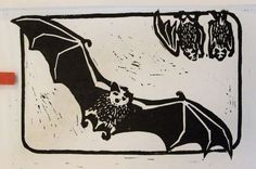 a black and white drawing of a bat hanging upside down