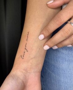 a woman's arm with a small tattoo on it that says, love is in the air