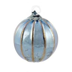 a blue glass ornament hanging on a white wall