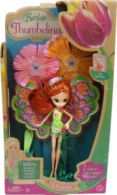 the doll is in its box and has pink flowers on her head, as well as an umbrella