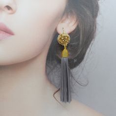 Add a touch of elegance to any outfit with these handmade earrings featuring a gold plated brass filigree locket with faux pearls and aquamarine tassels. Made with a long lasting gold plating layer and based on an ancient Chinese recipe, the herb beads in the locket are made in Taiwan with generations of heritage in traditional Chinese medicine using 100% plant-based ingredients with unique properties to enhance wellness. These earrings feature vermeil ear wires and are made to order in a size o Elegant Beaded Tassel Earrings, Elegant Gold Tassel Earrings As Gift, Elegant Gold Tassel Earrings For Gift, Elegant Wedding Tassel Earrings With Latkans, Elegant Handmade Silver Tassel Earrings, Elegant Gold Jewelry With Tassels, Elegant Gold Tassel Jewelry, Elegant Dangle Tassel Earrings With Latkans, Elegant Tassel Earrings In Brass