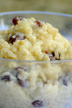 a bowl filled with rice and raisins on top of a white table cloth