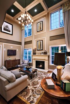 a living room filled with furniture and a fire place in the middle of a room