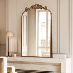 a mirror sitting on top of a fireplace in a living room