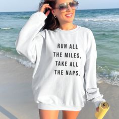 Looking for the perfect Minimalist runner sweatshirt? Look no further! Get ready to be obsessed with your new running sweatshirt. It is the cutest and most trendy way to emit all those running vibes with a flare of the minimalist! quote "Run All the Miles, Take All the Naps." This is the perfect running aesthetic shirt mixed with minimalist vibes. Grab it for yourself or make it a great gift for a loved one! * Q U I C K * F A C T S * ✺ 100% preshrunk cotton ✺ Wash and dry normally (on cool for best results) ✺ AVOID: bleach, dry cleaning, ironing * G I L D A N * S I Z I N G * ✺ Models are wearing size medium ✺ Sizing is unisex so runs like men's, though not overly large ✺ Most women find their typical size works best, since they are meant to fit a touch loose. If you like more of an over-si White Letter Print Sweatshirt For Gym, White Letter Print Sweatshirt For The Gym, White Graphic Print Sweatshirt For Workout, White Crew Neck Sweatshirt For Gym, Casual Winter Running Sweatshirt, Moisture-wicking White Sweatshirt For Workout, Casual Crew Neck Top For Running Errands, White Moisture-wicking Sweatshirt For Workout, White Moisture-wicking Crew Neck Sweatshirt