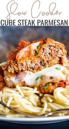 a close up of a plate of pasta with meat and sauce on it, text overlay reads slow cooker cube steak parmesan