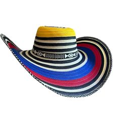 The Sombrero Vueltiao is a traditional Colombian hat known for its distinctive design and cultural significance. Originating from the Zenú indigenous people of the Caribbean coast, this hat is woven from cane-like fibers of the caña flecha plant. Its name, "Vueltiao," translates to "turned" in English, referring to the intricate process of turning the strips of caña flecha into a circular, spiral pattern. The hat's design features alternating black and white, beige patterns or colorful, symboliz Coronado Hat, Porto Rico, Spiral Pattern, Cultural Events, Functional Accessories, White Beige, Sun Hat, Straw Hat, The Caribbean