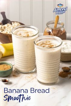 two glasses filled with banana bread smoothie on top of a table