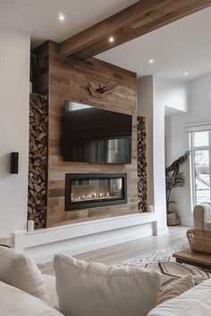 a living room with white couches and a flat screen tv mounted on the wall