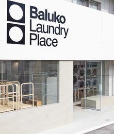 an image of a building that has laundry place on it's front window and the words baukko laundry place written in black