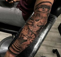 a person with a tattoo on their arm has an eye and clock in the background