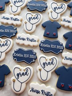 decorated cookies with blue and white frosting are arranged on a table in the shape of baby's first year