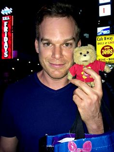 a man holding a teddy bear in his hand