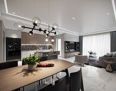 a modern kitchen and living room are shown in this image, while the dining table is surrounded by black chairs