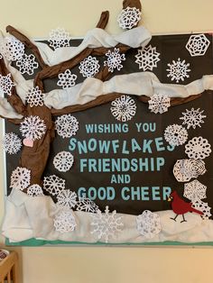 a bulletin board with snowflakes and a cardinal on it