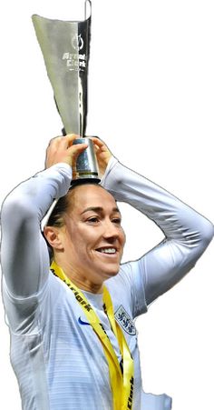 a woman holding up a silver trophy in the air with her head above her head