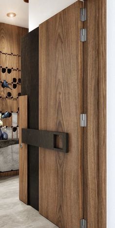 a wooden door with metal handles in a room