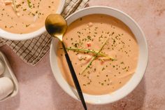 two bowls filled with soup on top of a table