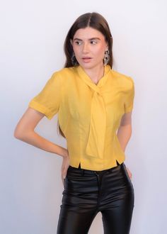 Luxury Semi-stitched Yellow Blouse, Elegant Yellow Formal Tops, Vintage Fitted Tops For Semi-formal Occasions, Fitted Vintage Tops For Semi-formal Occasions, Chic Fitted Tie Neck Shirt, Fitted Tie Neck Top For Workwear, Classic Fitted Tie Neck Blouse, Chic Fitted Tie Neck Blouse, Retro Short Sleeve Blouse For Work