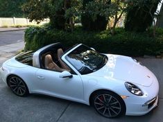 a white sports car is parked on the street