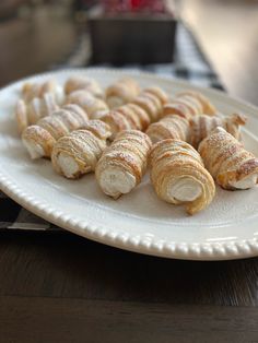 several croissants are on a white plate