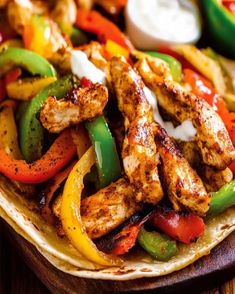 chicken fajita with peppers and onions on a tortilla