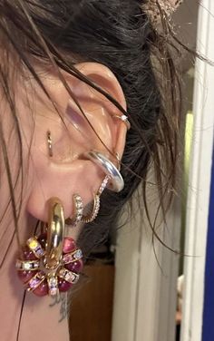 a close up of a person's ear wearing some kind of ear piercings