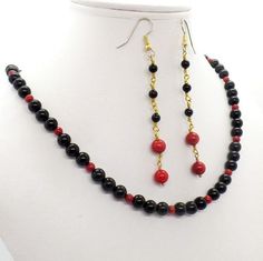 Elegant timeless black onyx is fired up with scintillating red onyx to form an exquisite necklace. The shoulder duster earrings of more gorgeous black onyx and red coral add vibrancy, excitement and excitement to the classic jewelry set. The gemstone necklace is approximately 15 1/2 inches long Elegant Red Earrings With Black Beads, Red Onyx Jewelry For Gift, Green Aventurine Necklace, Shoulder Duster Earrings, Duster Earrings, Green Aventurine Stone, Aventurine Necklace, Aventurine Stone, Coral Gemstone