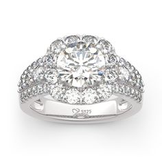 a diamond ring with two rows of diamonds on the band and a center stone surrounded by smaller stones