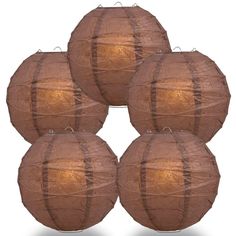 four brown paper lanterns sitting on top of each other