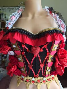 a mannequin wearing a red and black corset with flowers on it