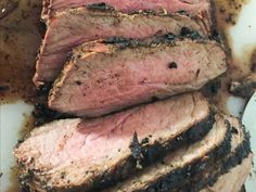 sliced meat sitting on top of a cutting board