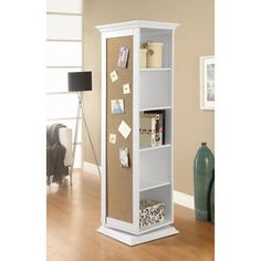 a tall white bookcase with cork and memos on it