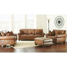 a living room filled with furniture and a large clock on the wall above it's windows