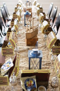 a long table with several chairs and tables covered in brown paper on top of it