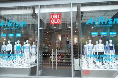 a store front with mannequins in the window and an uni - ollo sign