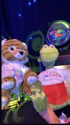 two stuffed animals sitting next to each other in front of a neon sign that says starlight circus