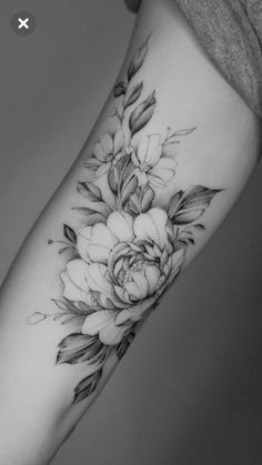 a black and white flower tattoo on the arm