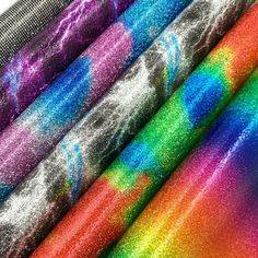 several different colors of glitter fabric on top of each other