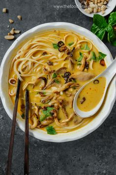 a white bowl filled with noodles and mushrooms