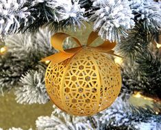 a yellow ornament hanging from a christmas tree