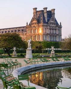 green lawn chairs in front of a large building