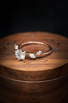 two rings sitting on top of a wooden box