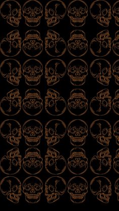 a bunch of skulls that are on a black background with gold lines in the middle