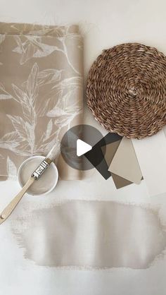 a white table topped with lots of different types of paper and paintbrushes on top of it