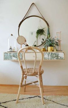 a chair sitting in front of a mirror on top of a wooden floor next to a rug